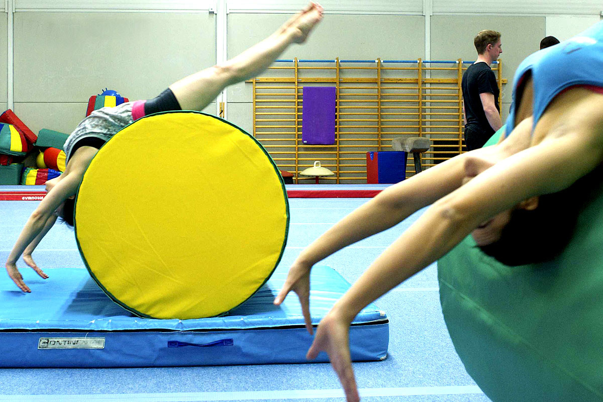 adult gymnastics session with male participants getting ready to train