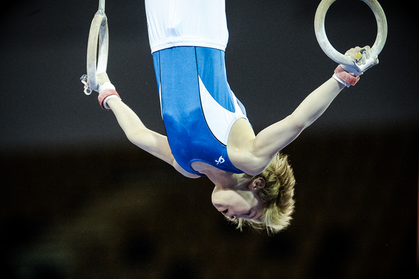 Young gymnast showing his talent on the rings