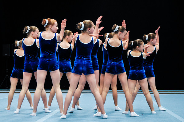 Perfectly in time, TeamGym gymnasts perform their perfected routine in matching 