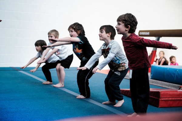 youngsters having fun on the floor apparatus