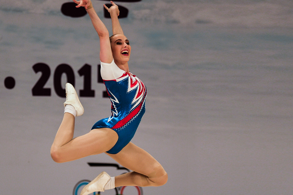 gymnast jumps for joy at aerobic world age group competition